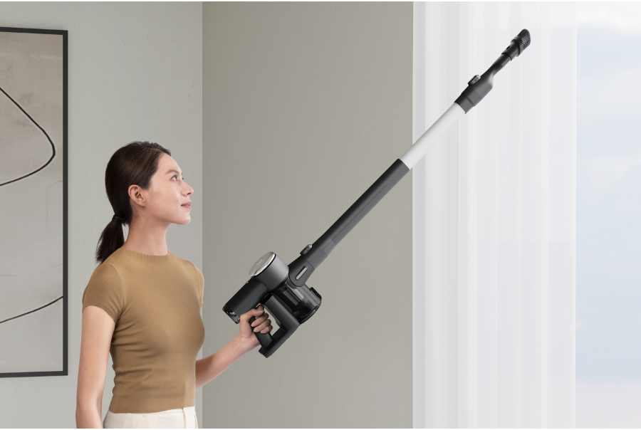 woman holding a vacuum cleaner