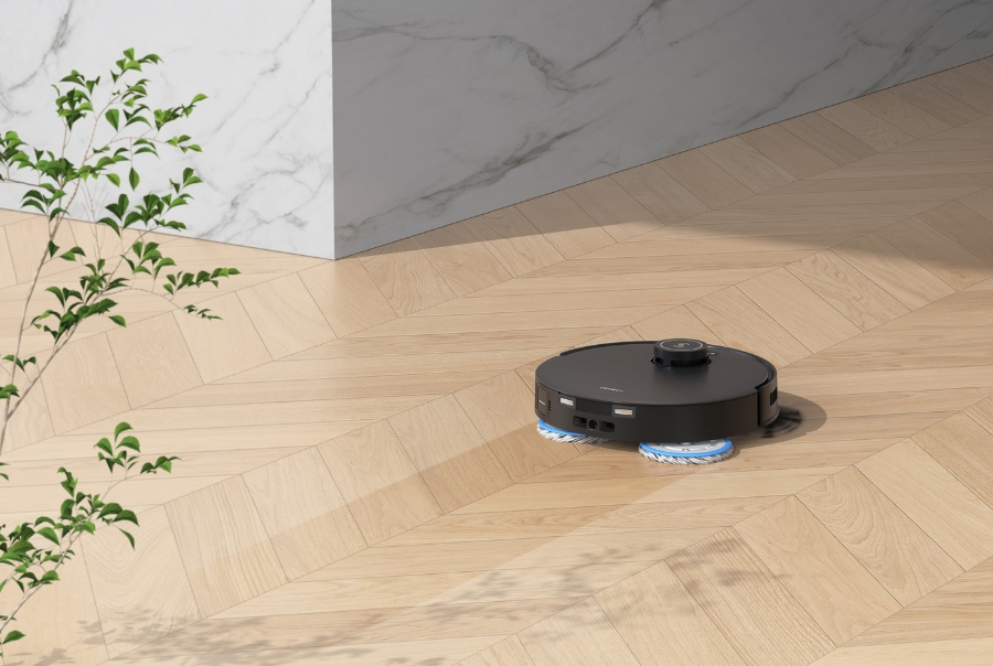 deebot robot vacuum is vacuuming and mopping on hardwood floor