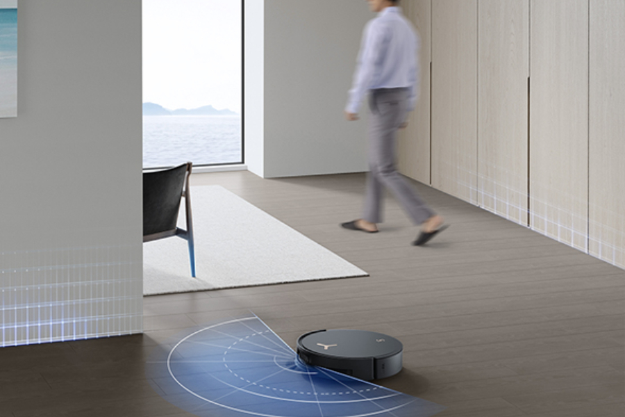 a robot vacuum cleaner working in a kitchen