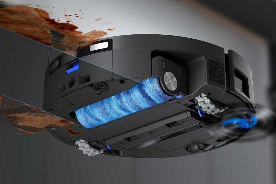 a close up of deebot robot vacuum roller mop removing stain on the floor