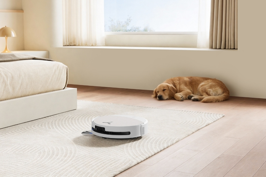 deebot robot vacuum vacuuming pet hair near dog