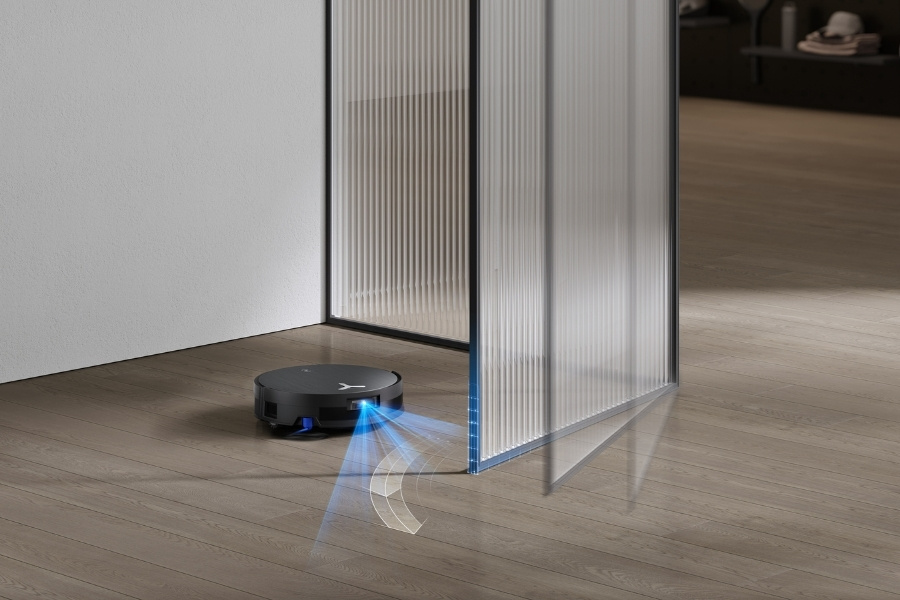 deebot robot vacuum cleaning around an opening door
