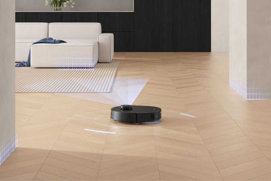 robot aspirateur deebot qui scanne une chambre avec du parquet
