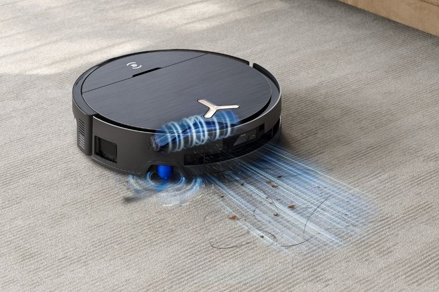 aspirateur robot deebot aspirant des poils de chien sur un tapis
