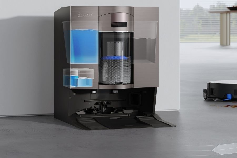 aspirateur robot deebot lavant le sol pres de la station de recharge