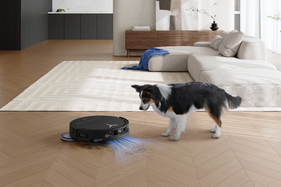 dog next to robot vacuum cleaner