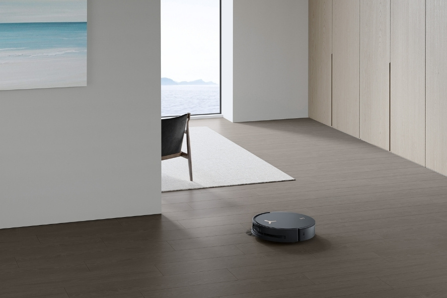 deebot robot vacuum vacuuming tile floors in the living room