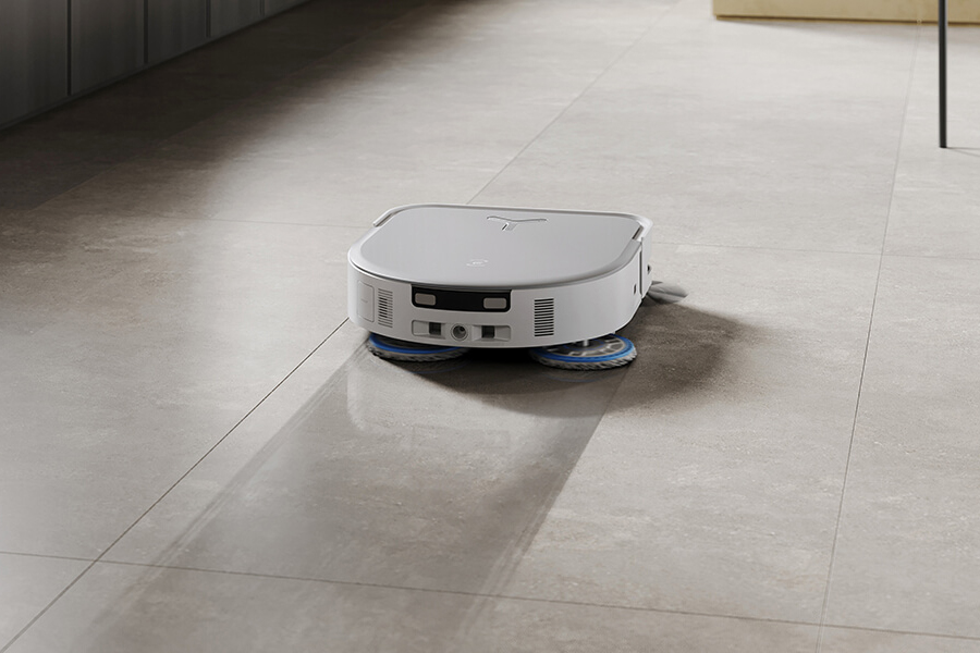 deebot robot vacuum vacuuming hair from tile floors in powder room