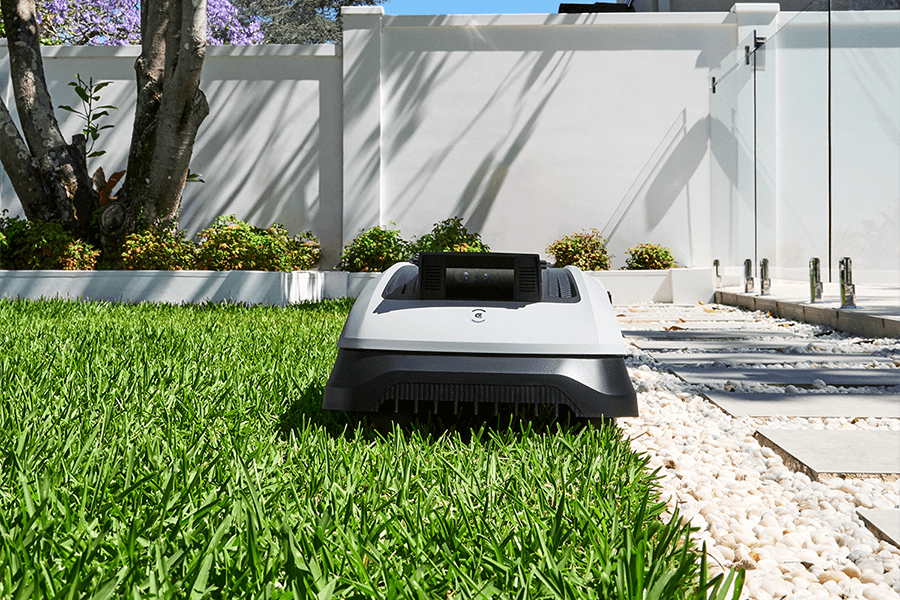 goat robot mower mowing edge of the lawn