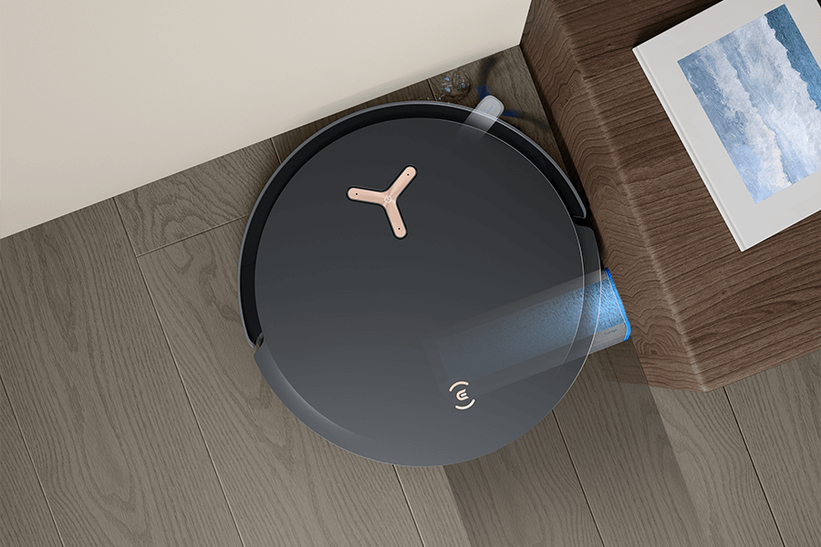 deebot robot vacuum cleaning pine needles in the corner