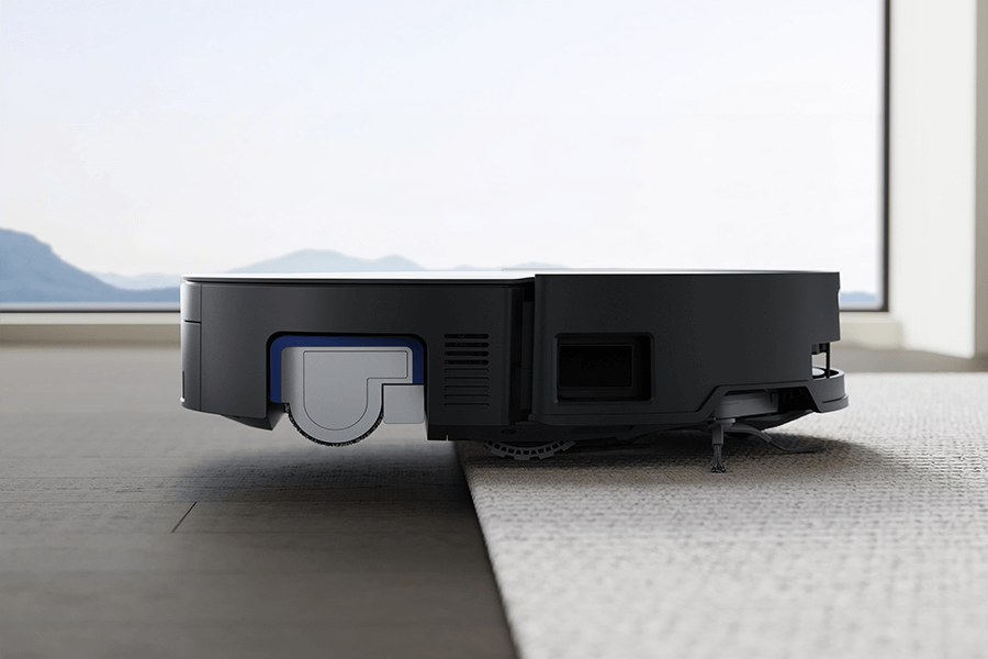 a close up of deebot robot vacuum lifting roller mop when vacuuming shag rug