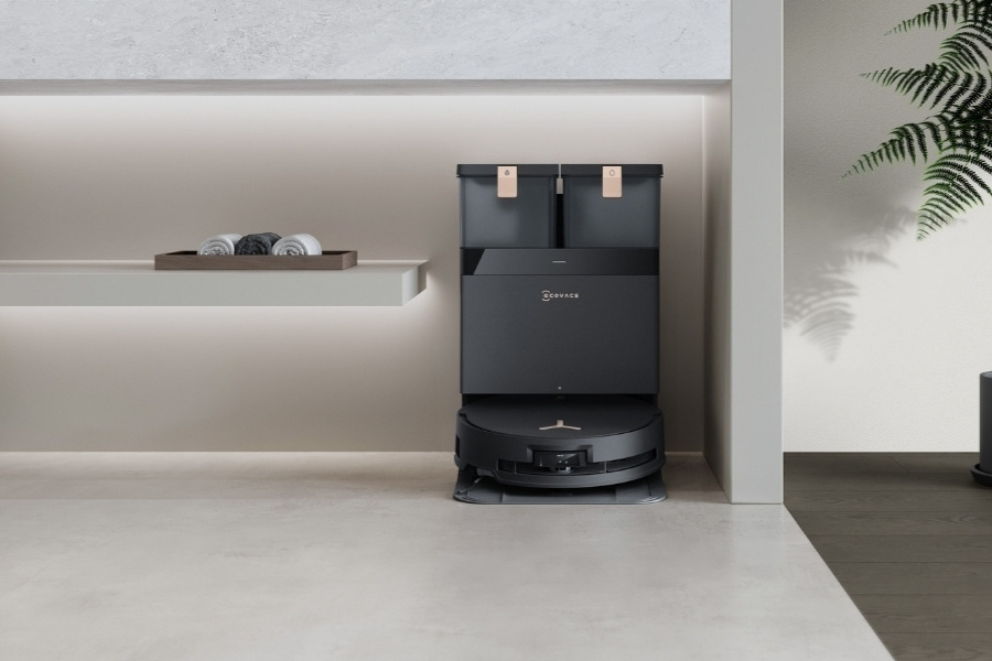 deebot robot vacuum charging at powder room with stone tile floors