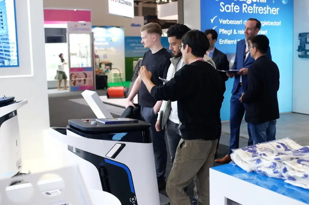 staff explaining ECOVACS Commercial Cleaning Robot