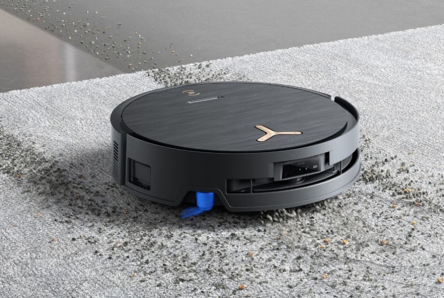 deebot robot vacuum vacuuming debris on carpet