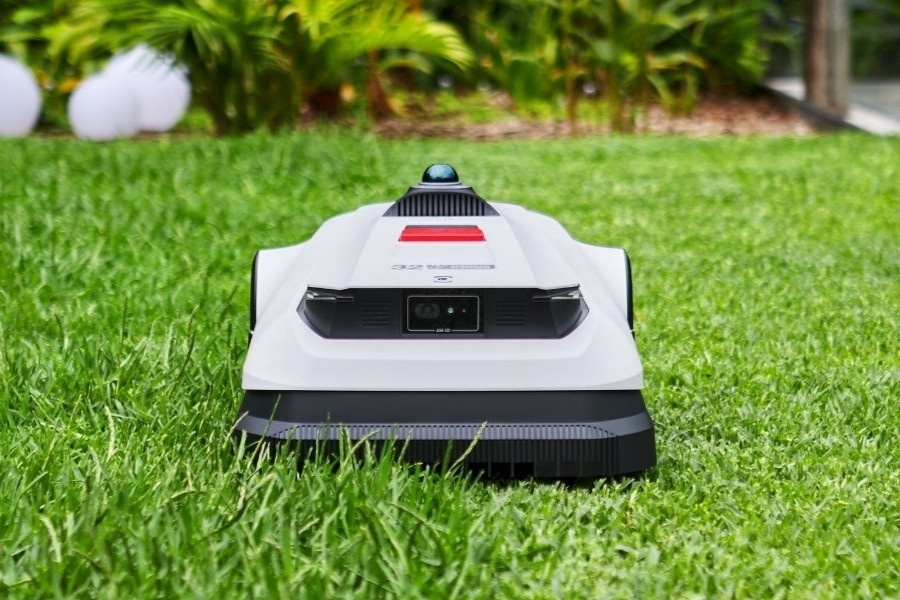 goat robot mower trimming a small lawn