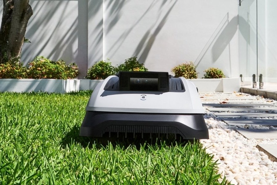 goat robot lawn mower cutting grass along the edge