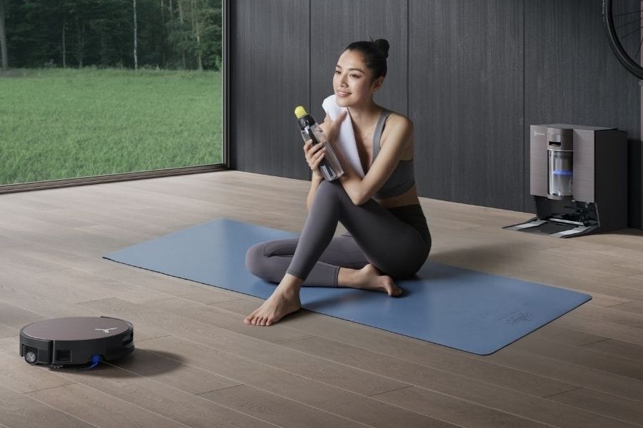 deebot robot vacuum mopping laminate floor in the gym