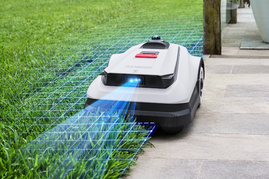 goat robot lawn mower navigating the edge of a yard