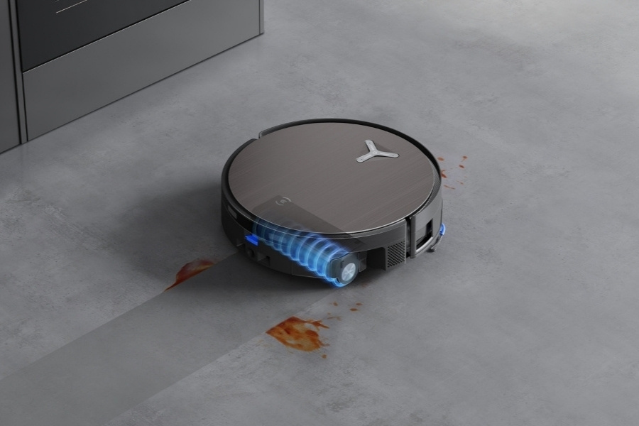 deebot robot vacuum mopping away coffee stains on concrete floor