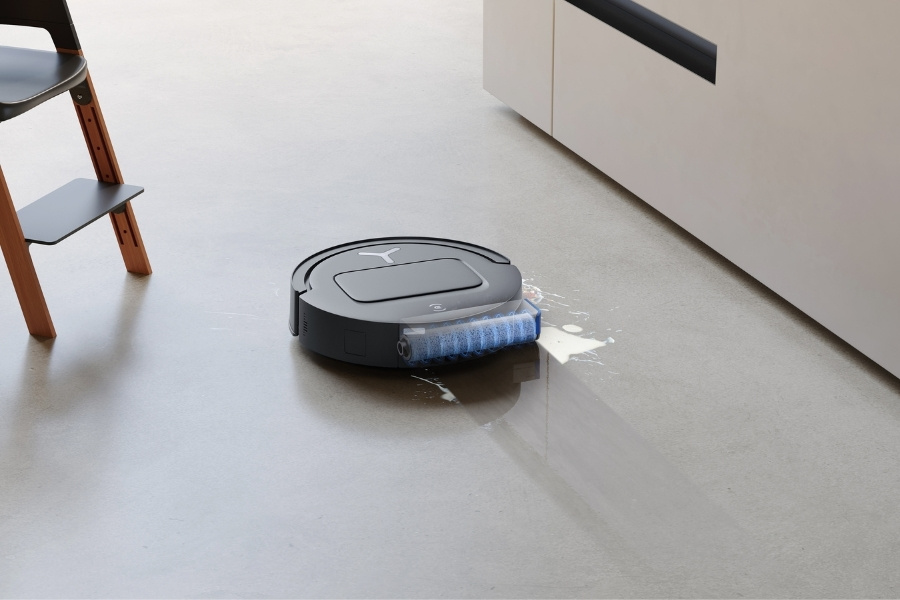 deebot robot vacuum cleaner mopping milk near a baby chair