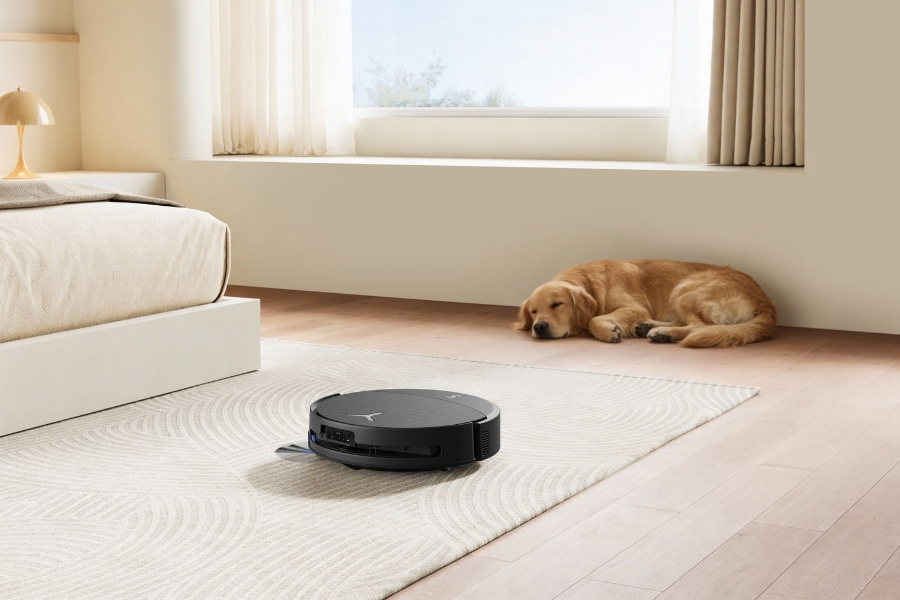 deebot robot vacuum vacuuming pet hair near dog