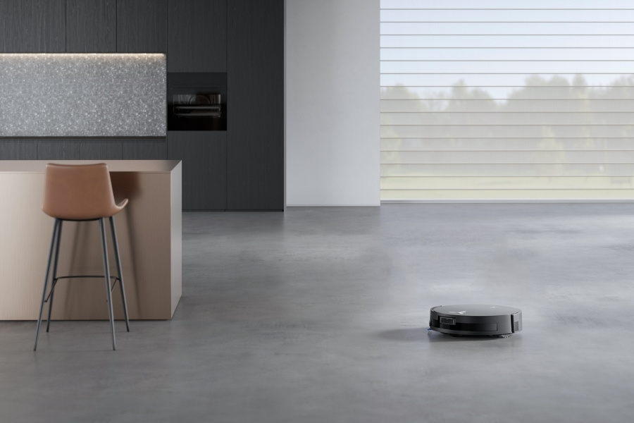 deebot robot vacuum cleaning near a kitchen counter