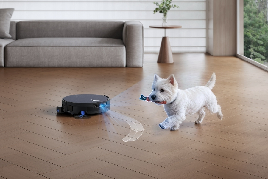 deebot robot vacuum cleaning the living room while avoiding a dog